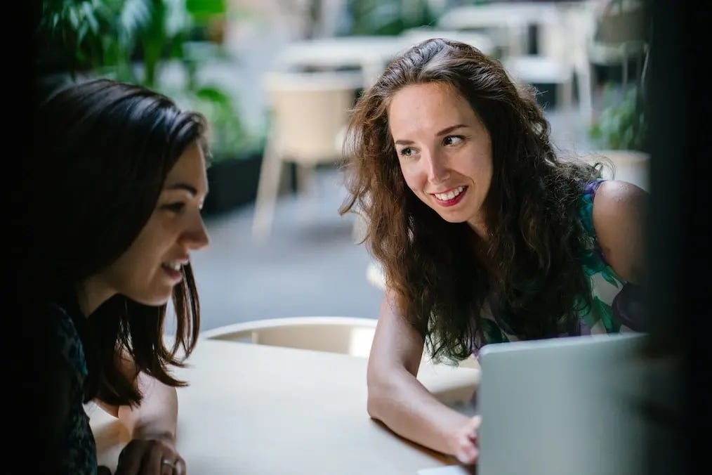two-talking-women-while-using-laptop-1311547-1024
